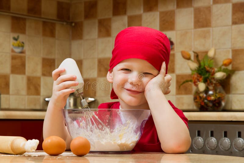 Boy helping at kitchen with baking pie