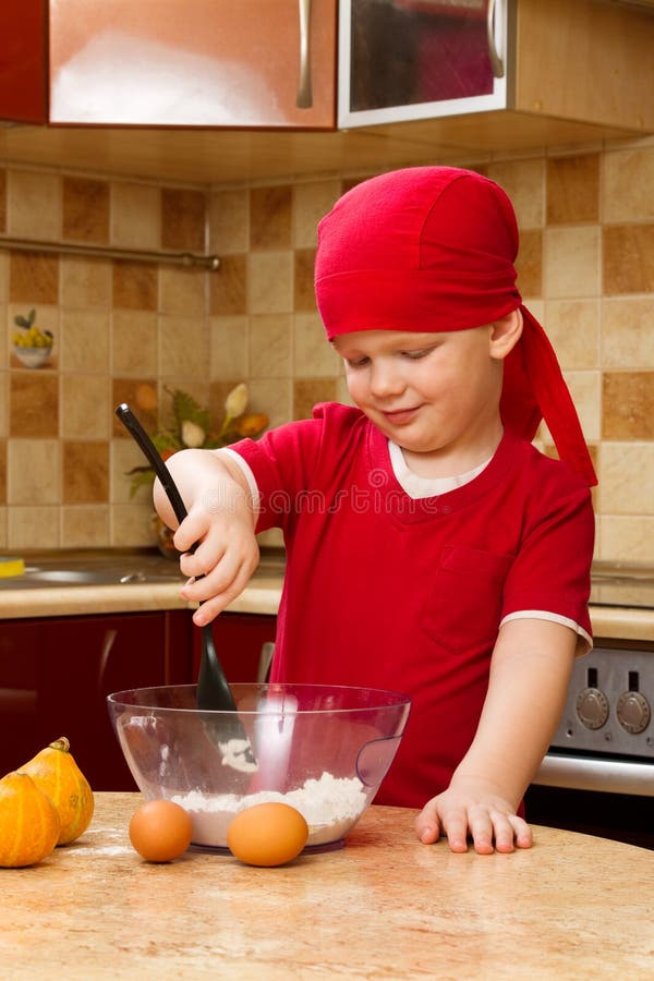 Boy helping at kitchen with baking pie