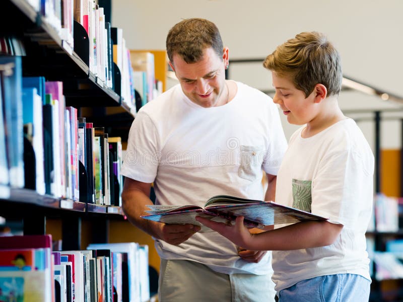 Boy and his father in library