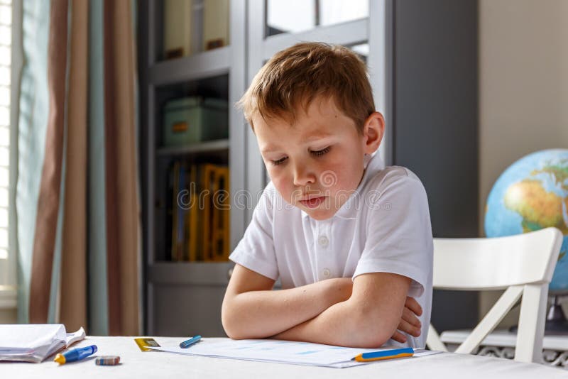 Boy doing his homework and studying. Boy doing his homework and studying