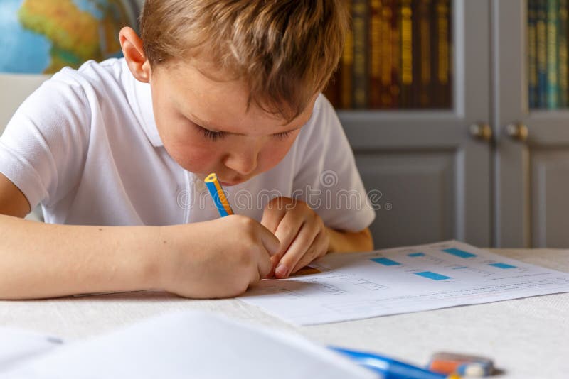 Boy doing his homework and studying. Boy doing his homework and studying