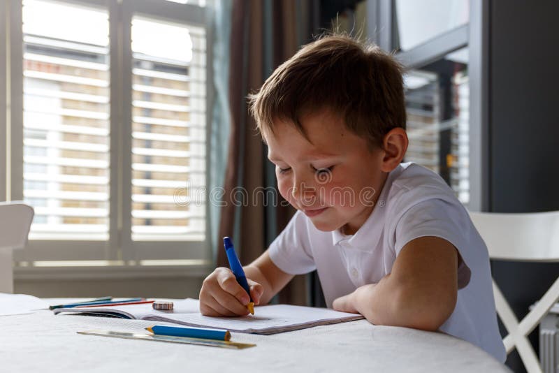 Boy doing his homework and studying. Boy doing his homework and studying