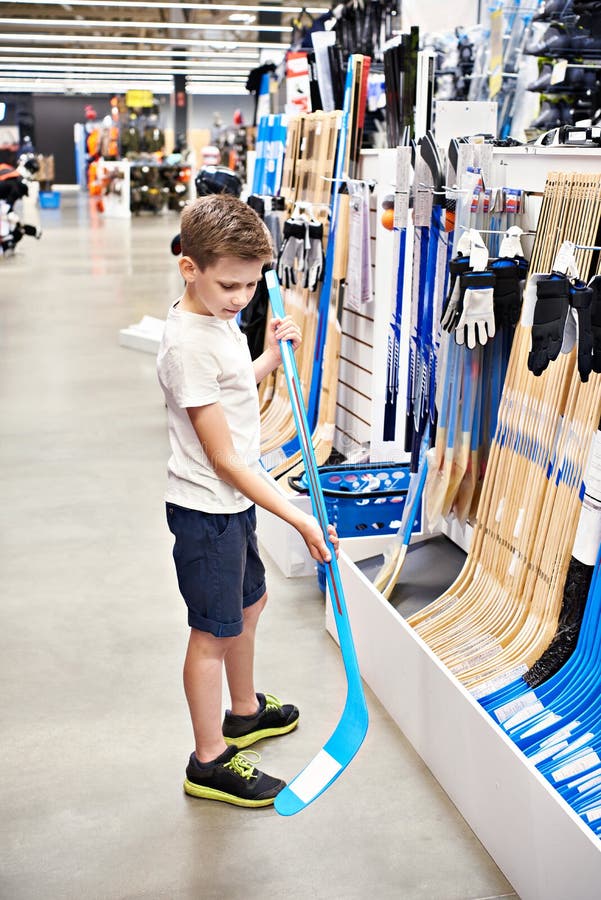 Boy with Hockey Stick in Sport Store Stock Image Image of goods