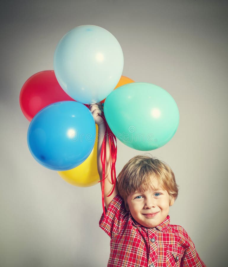 Boy Holding The Bunch Of Balloons Stock Image Image of colors