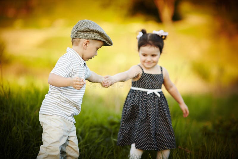 Boy holding girl s hand stock image. Image of backlit 28918359