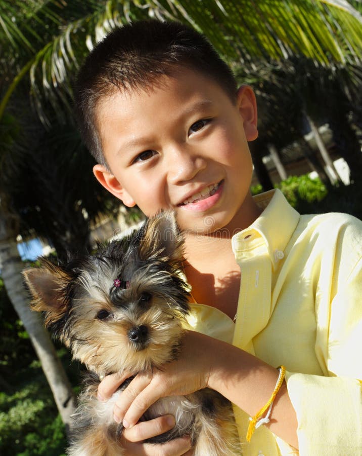 Boy holding his puppy