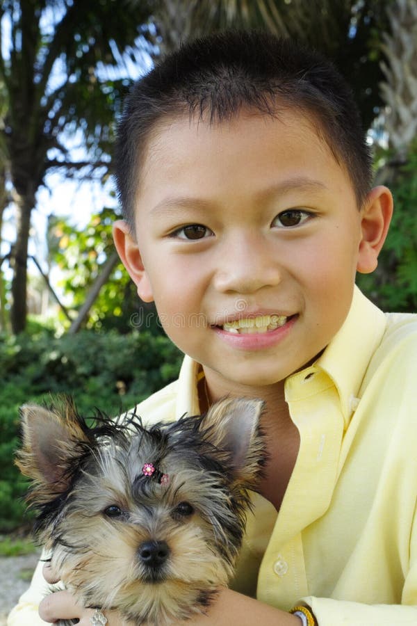 Boy holding his puppy