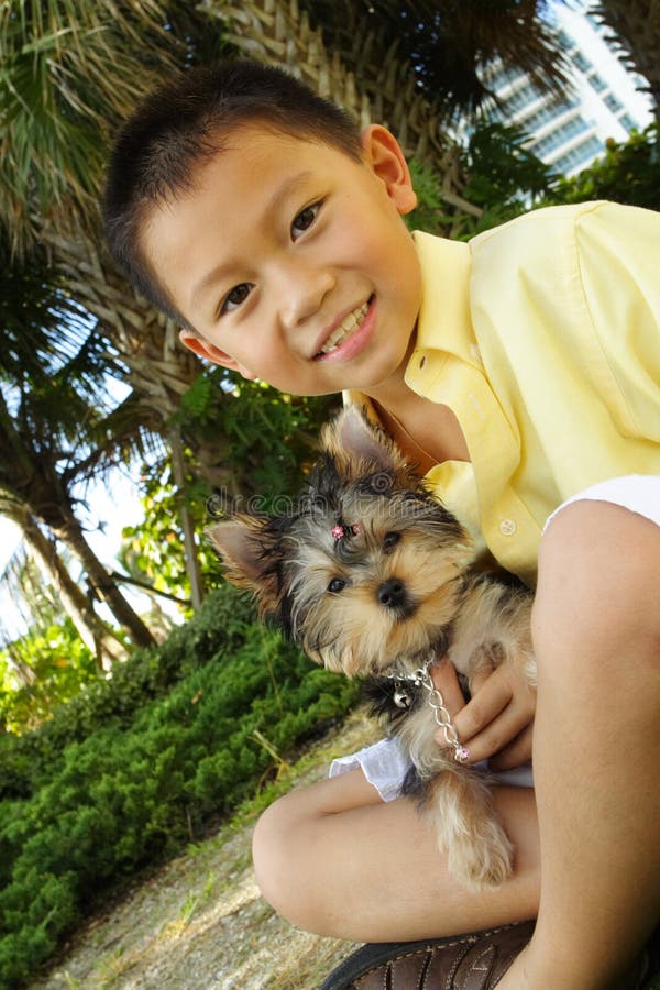 Boy holding his puppy