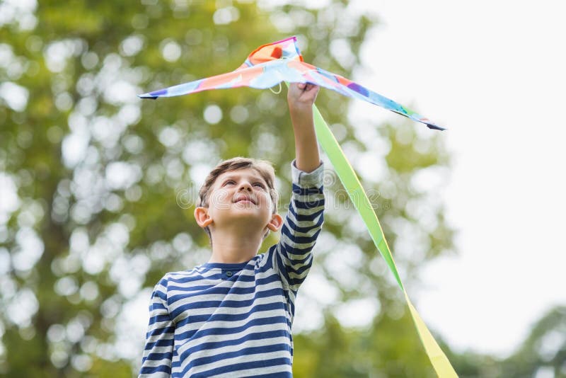 Boy holding a kite in park stock image. Image of activity 77905445