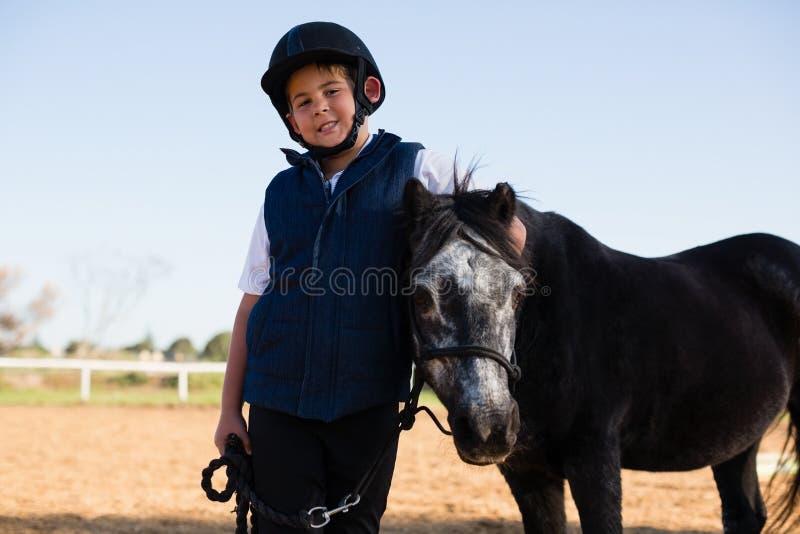 Boy Holding the Reins of a Horse in the Ranch Stock Photo Image of childhood, bonding 97394466