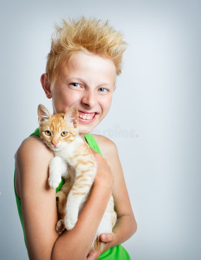 Boy hugging ginger kitten stock photo. Image of positive 56324288