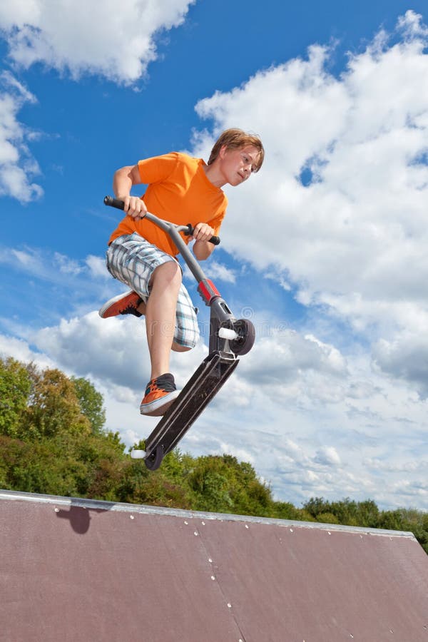 Boy jumping with his scooter