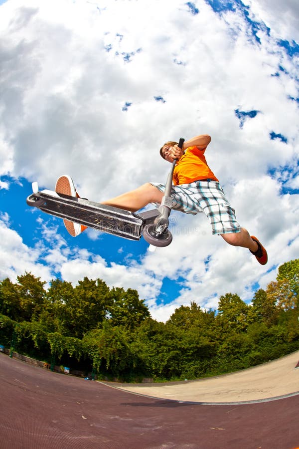 Boy jumping with his scooter