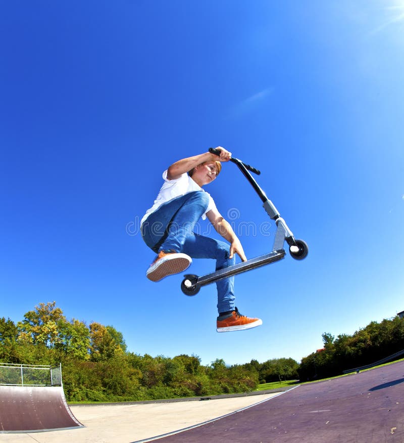 Boy jumping with his scooter