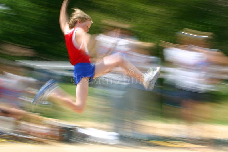 Motion blur of boy jumping at a track and field competition. Motion blur of boy jumping at a track and field competition