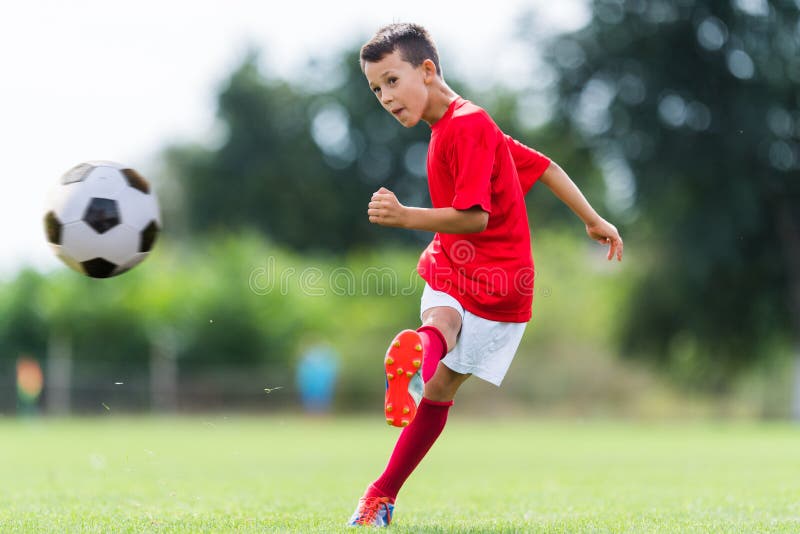 Boy kicking soccer ball