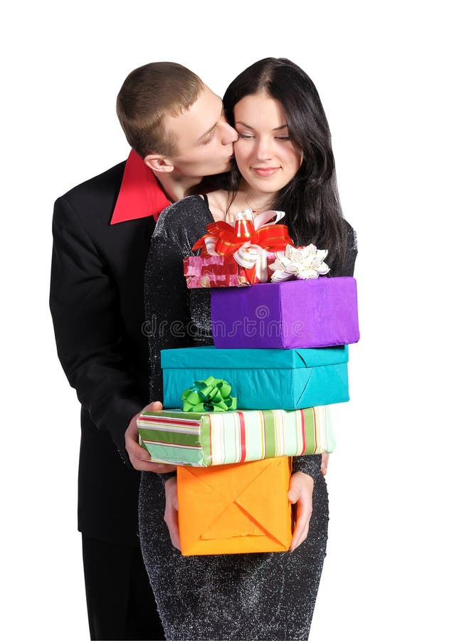 Boy kisses the girl, holding a box of gifts