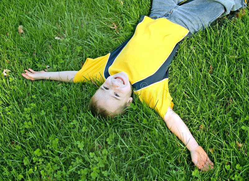 Boy Laying on Grass