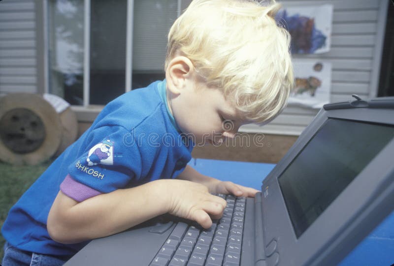 A boy learning to use a laptop computer in Washington, D. C. stock photography