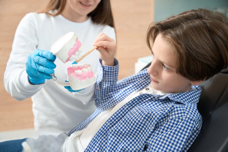 Boy Learns To Properly Care for His Teeth and Braces Stock Image