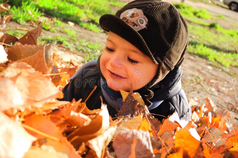 Boy in leaves