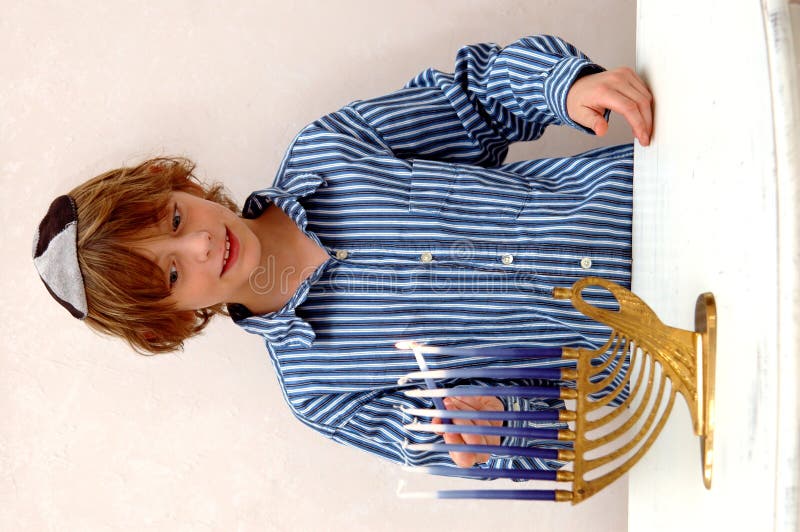 Boy lighting Menorah stock photography Boy lighting Menorah stock photography