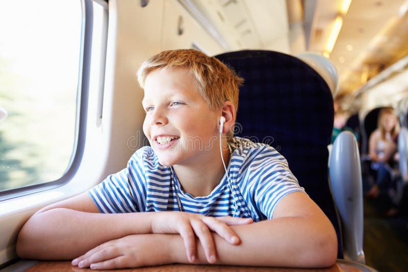 Boy Listening To Music On Train Journey royalty free stock image Boy Listening To Music On Train Journey royalty free stock image