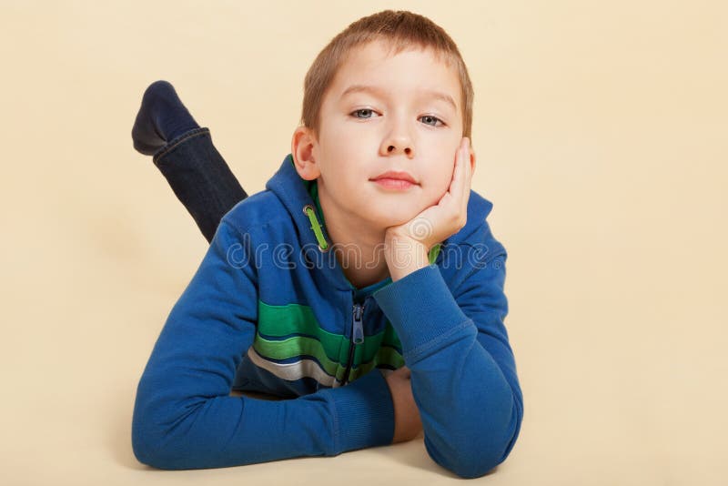 Boy looking into the camera and thinking.