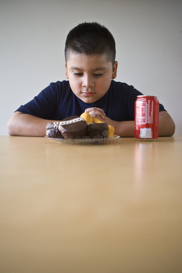 Boy Looking At Dessert On table