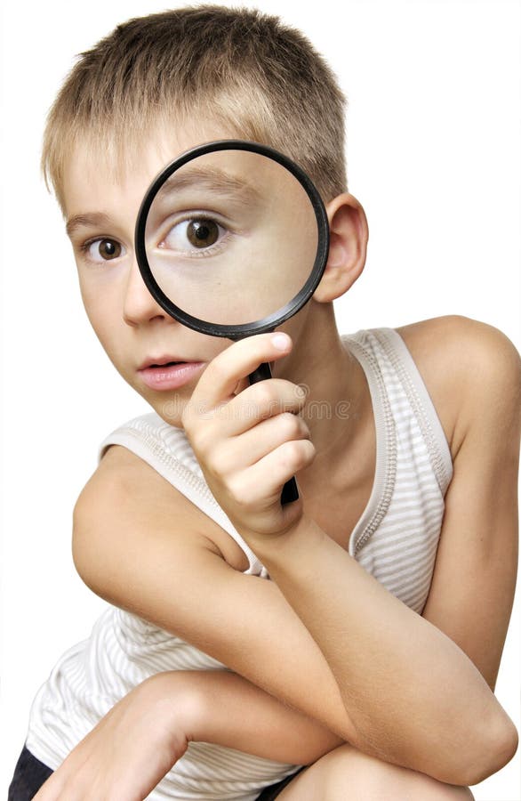 Boy looking through a magnifying glass