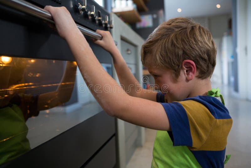 Boy looking at oven stock photo. Image of caucasian, child 97402462