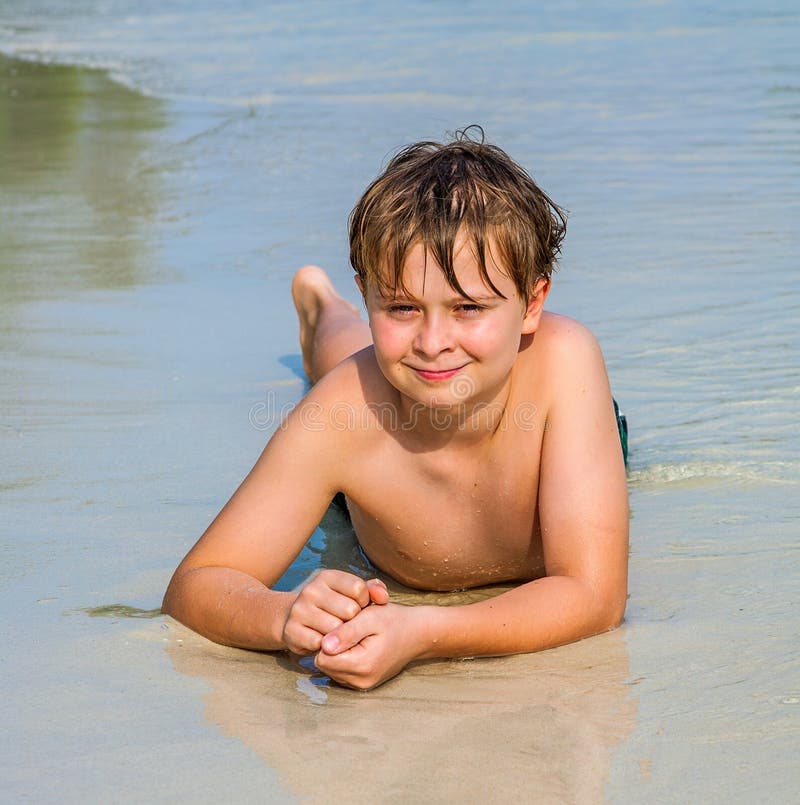 Boy is lying at the beach