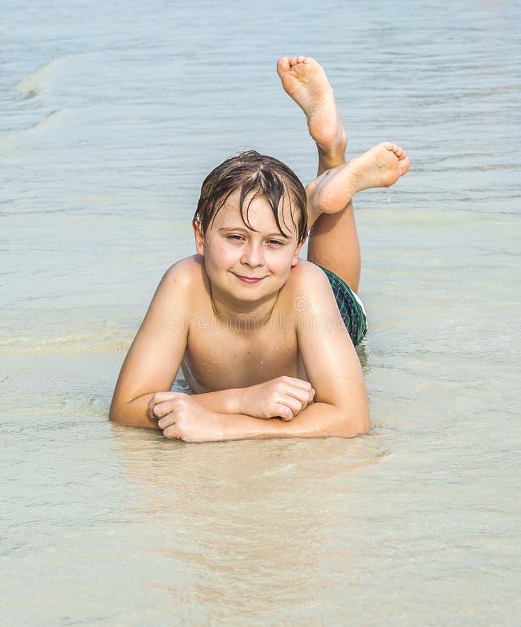 Boy is lying at the beach