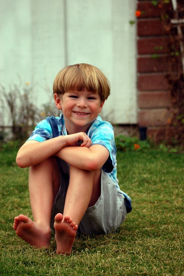 Boy lying down in grass stock photo. Image of grass, cheerful - 1427938