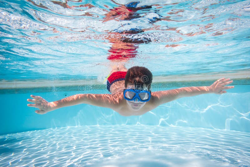 Boy in mask dive in swimming pool stock photos Boy in mask dive in swimming pool stock photos