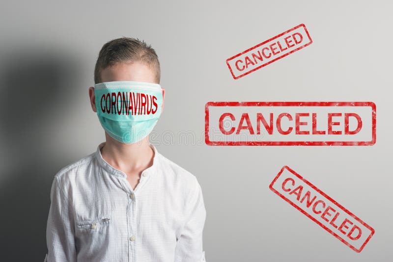 Boy in a medical mask with red inscription CORONAVIRUS on his face on bright background. Epidemic virus 2019-nCoV Respiratory