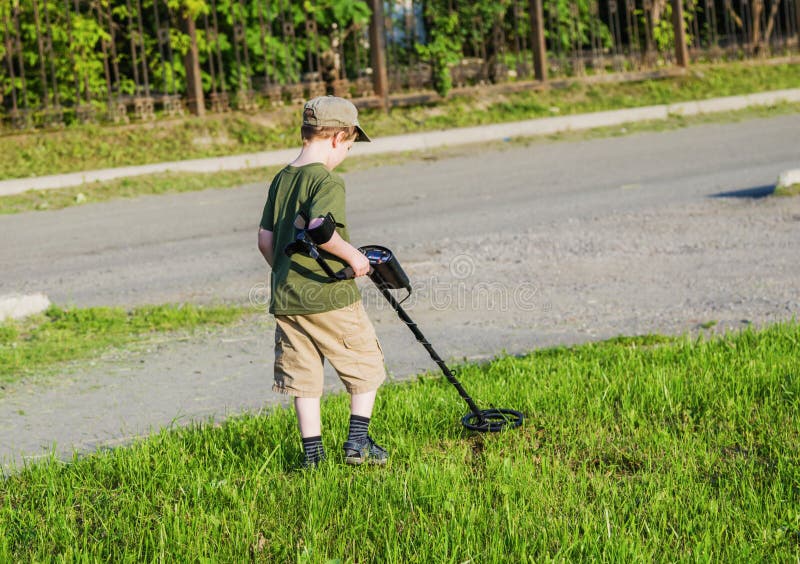 Boy with a metal detector stock image. Image of archaeology 97753315