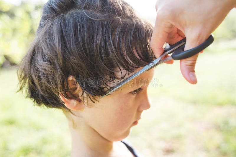 Boy with a New Haircut, a Woman Cuts the Hair of a Child in the Yard of the  House during Quarantine Stock Photo - Image of cutting, coronavirus:  184040820