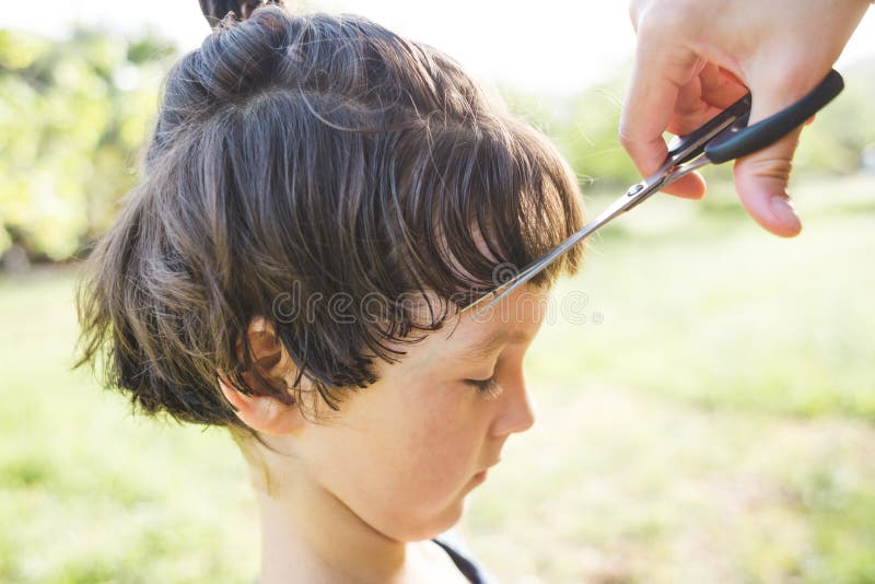 Boy with a New Haircut, a Woman Cuts the Hair of a Child in the Yard of the  House during Quarantine Stock Photo - Image of isolation, hair: 198921388