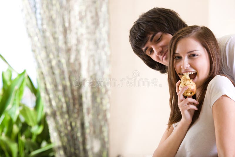 Boy and nice girl with pear