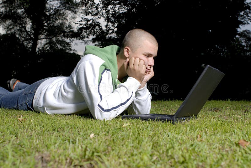 Boy with notebook in park