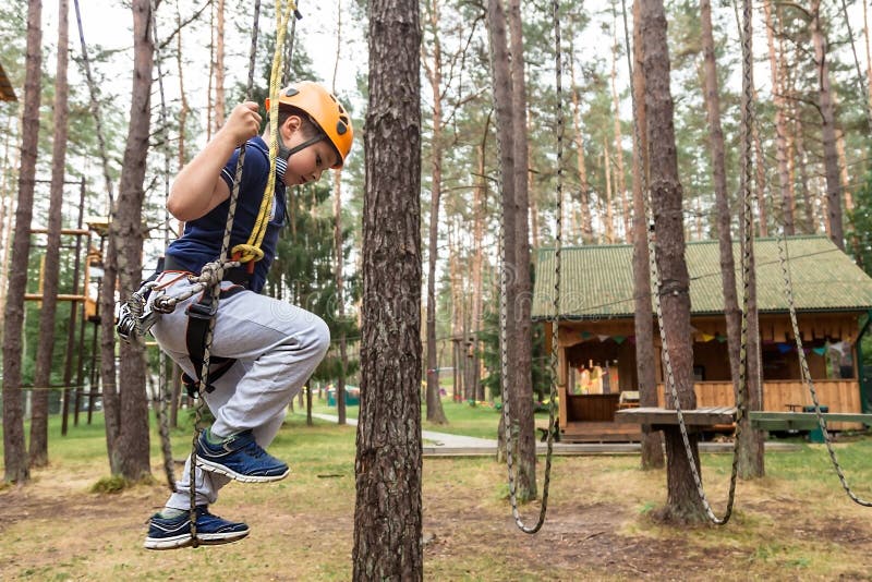 The boy overcomes the obstacle of the rope town royalty free stock photos The boy overcomes the obstacle of the rope town royalty free stock photos