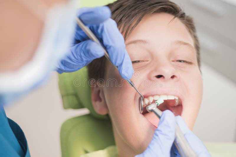 Boy with perfect teeth happy at the dentist royalty free stock photo Boy with perfect teeth happy at the dentist royalty free stock photo