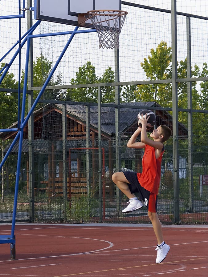 Boy playing basketball, jump and shot