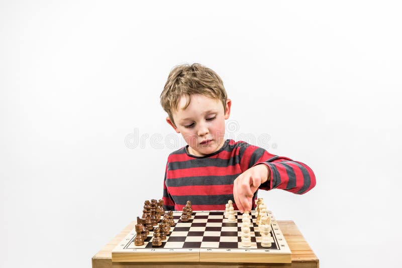 Young white child playing a game of chess on large chess board. Chess board  on table in front of school boy thinking of next move by Len44ik Vectors &  Illustrations with Unlimited