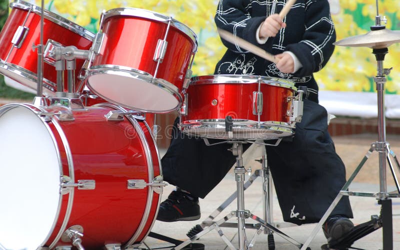 A boy playing drum kit