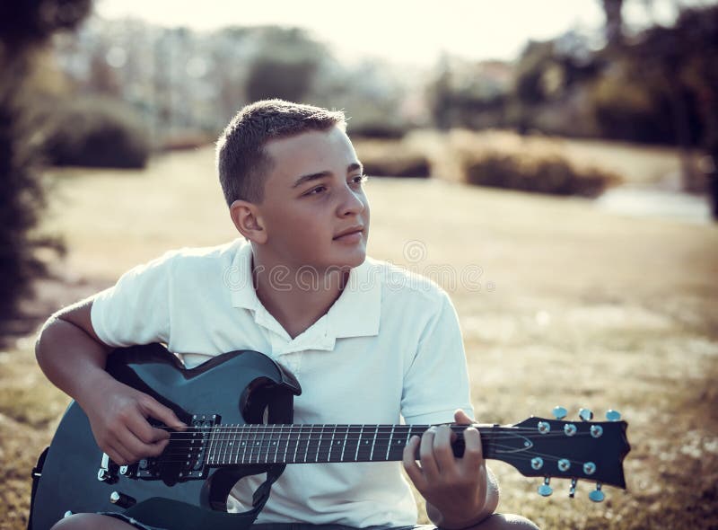 Boy playing electric guitar