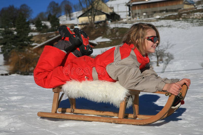 Boy playing on old sledge