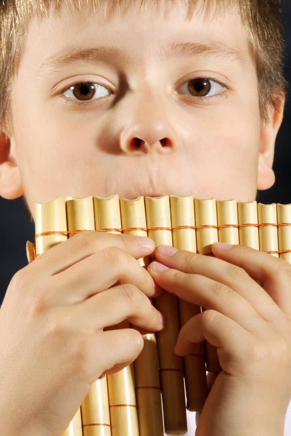 Boy playing panflute royalty free stock image