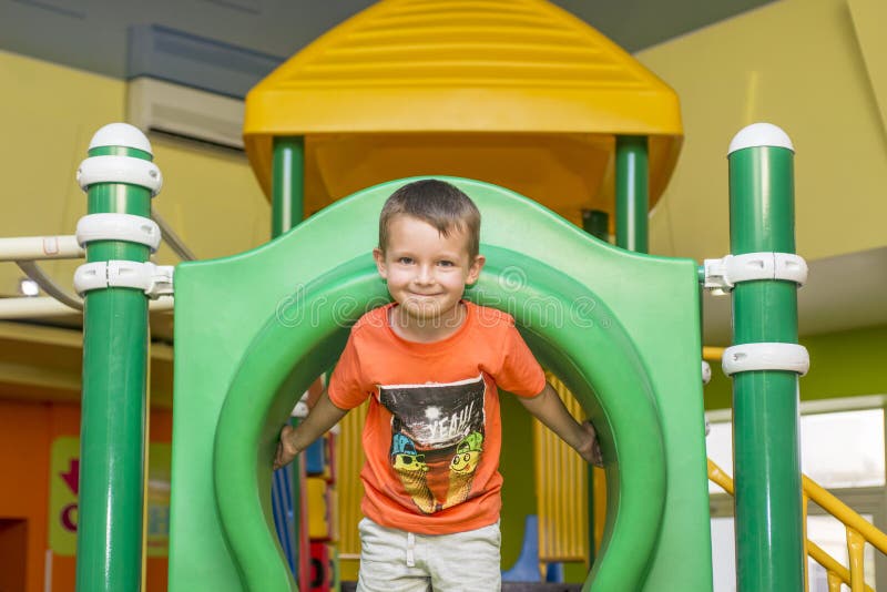 Boy playing on the playground, in the children`s maze. Cute boy having fun on playground